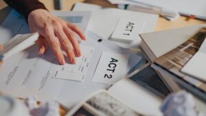 man looking through recently printed documents